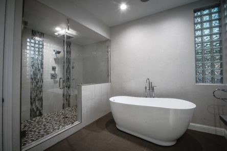 Spacious remodeled bathroom in Westlake Village with walk-in glass shower, mosaic accent tiles, and a modern freestanding soaking tub.