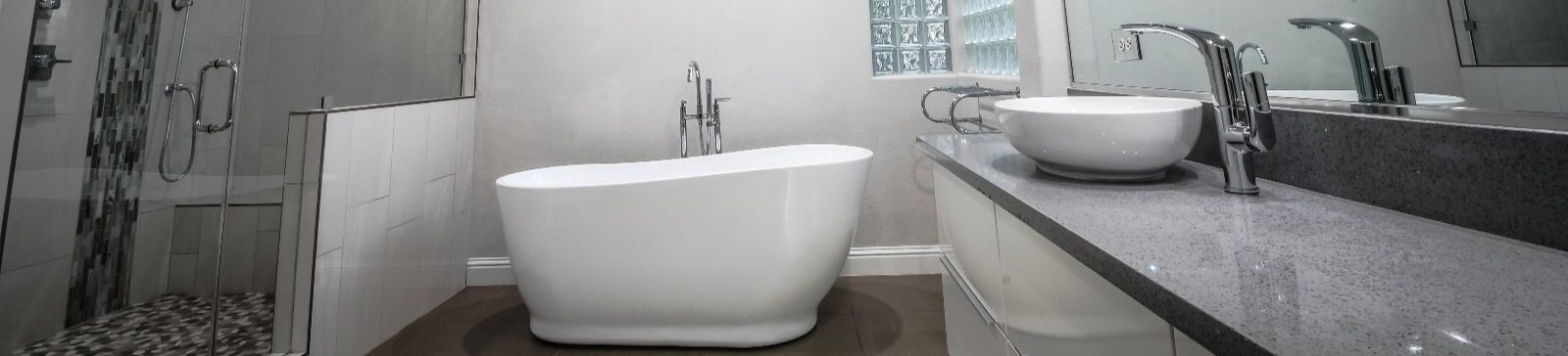 Spacious remodeled bathroom in Westlake Village with walk-in glass shower, mosaic accent tiles, and a modern freestanding soaking tub.