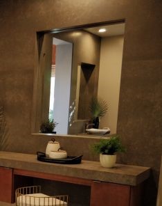 Modern remodeled bathroom in Simi Valley with custom corner vanity, wood-look tile flooring, and spa-inspired decor.