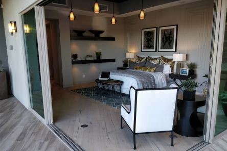 Modern remodeled bathroom in Simi Valley with custom corner vanity, wood-look tile flooring, and spa-inspired decor.